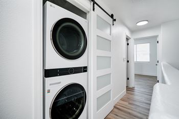 A white LG washing machine and dryer in a small laundry room.